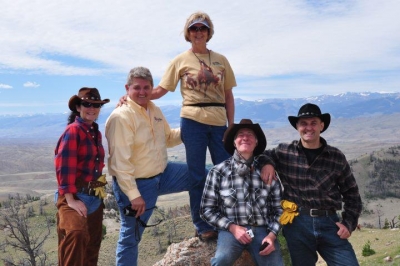 Family posing for an outdoor ranch photo.