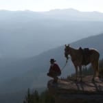 The Hideout Lodge & Guest Ranch - horseback rider standing on an overlook.