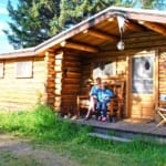 Moose Head Ranch - couple sitting on a cabin porch.