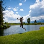 Moose Head Ranch - boy jumping into a the river.