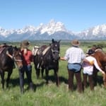 Moose Head Ranch - Horseback riders looking at the mountains.