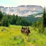 Red Rock Ranch - Horseback riders on the field..