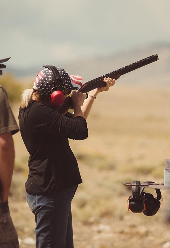 Woman aiming for trapshooting.