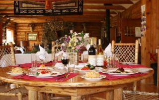 Dining table with wine and plated meals.