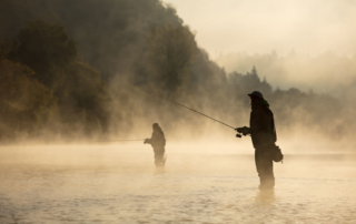 Photo of two people fly fishing: a popular dude ranch activities in Wyoming