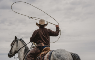 Wrangler on a horse: a common dude ranch job in Wyoming