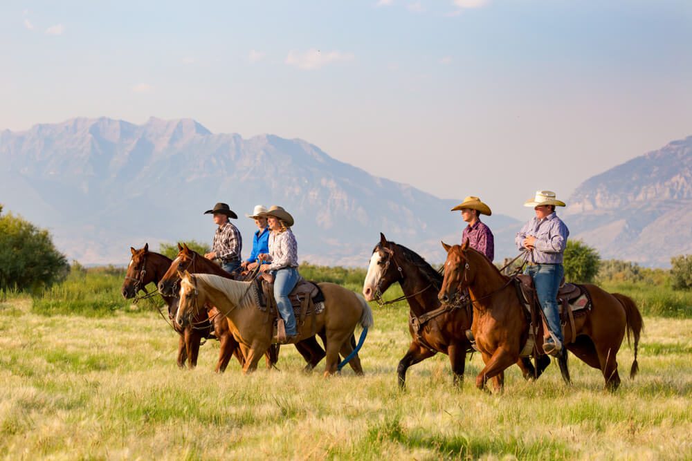 People riding horses at Wyoming guest ranches