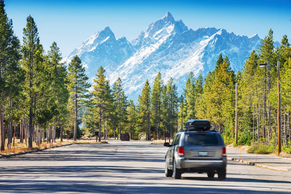 Car traveling through Wyoming mountains on the way to a dude ranch