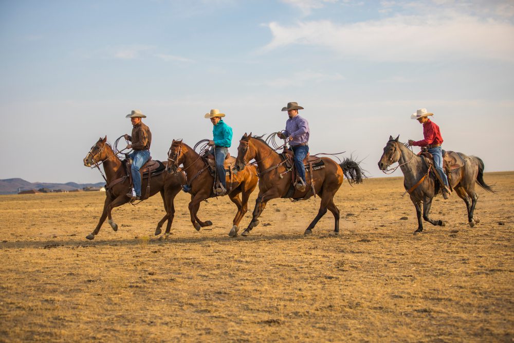 group of friends riding horses during a dude ranch bachelor party