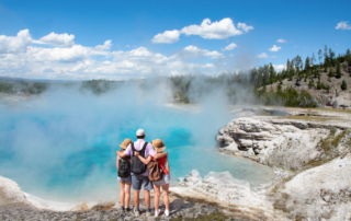 Family in front of hot spring at Yellowstone
