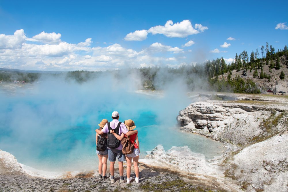 Family in front of hot spring at Yellowstone