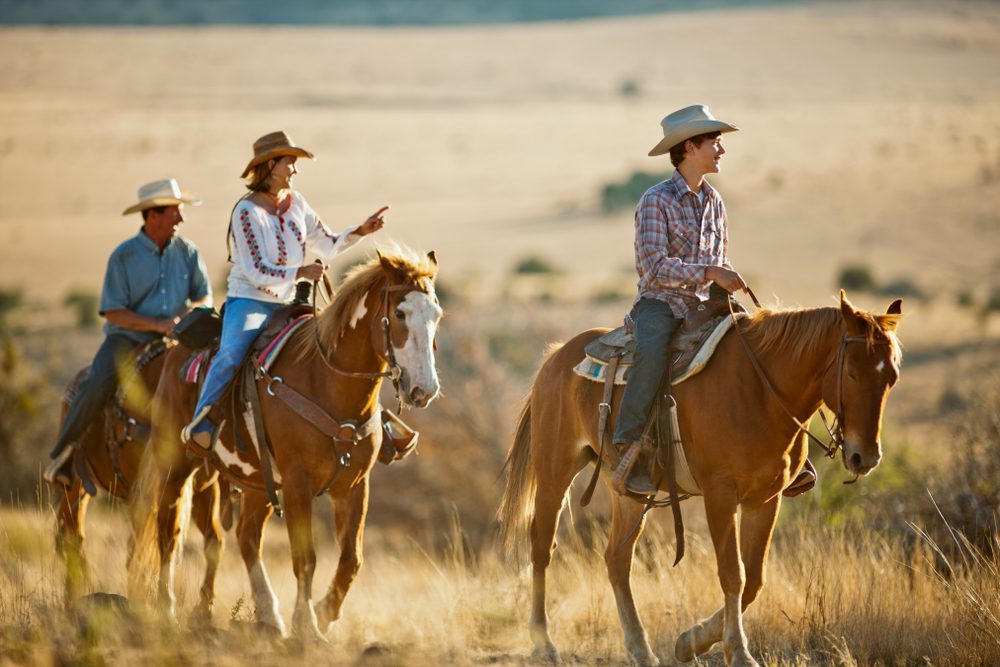 family horseback riding at a dude ranch vacation in wyoming